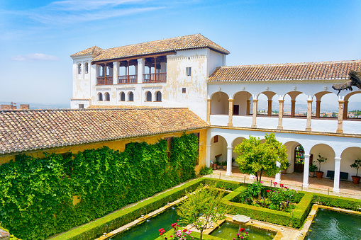 SEVILLE, SPAIN - OCTOBER 18.2020: Palace of Alcazar in Seville, Famous Andalusian Architecture. Old Arab Palace in Seville, Spain. Ornamented Arch and Column. panorama