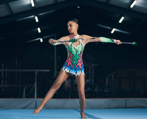 istock Woman, gymnastics and sticks in gym for training, dancing and performance with creativity, balance and wellness. Female gymnast, athlete and dance for workout, sports and prepare for competition 1618376530