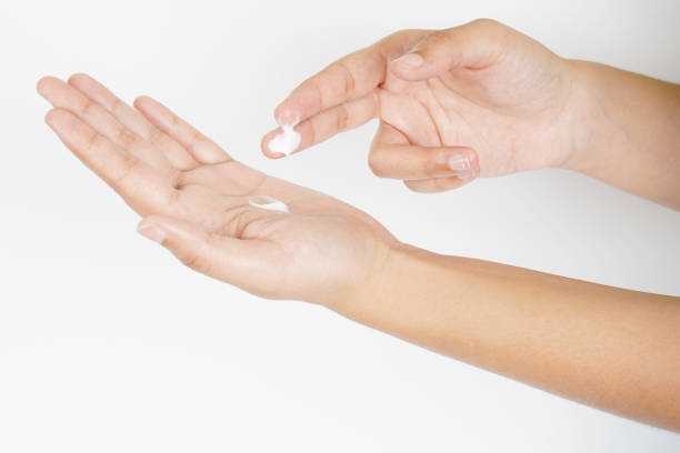 istock Applying cream in hand on white background 1618381365