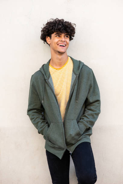 istock trendy young North African man laughing by white wall 1618385205