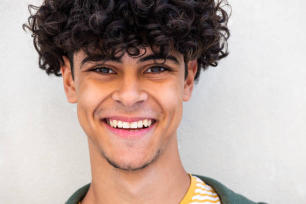 istock Close up smiling young North African man by white wall 1618385209