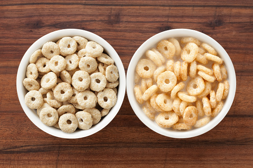 Top view of two bowls side by side with vanilla and breakfast cereal rings with and without milk