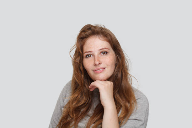 istock Confident woman looking at camera on white background 1618393327
