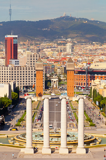 Plaza España in Barcelona city and cityscape seen from Montjuic mountain. Catalonia, Spain. Tibidabo mountain and clear sky in the background.