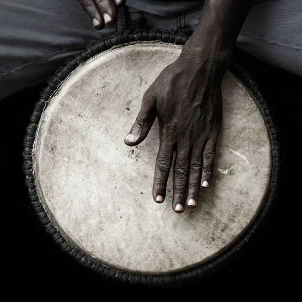 West African man palying djembe.
