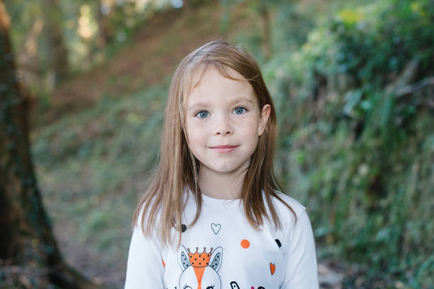 ragazza sorridente del bambino nel parco estivo, primo piano del viso. bambino 6 anni - 6 7 years foto e immagini stock