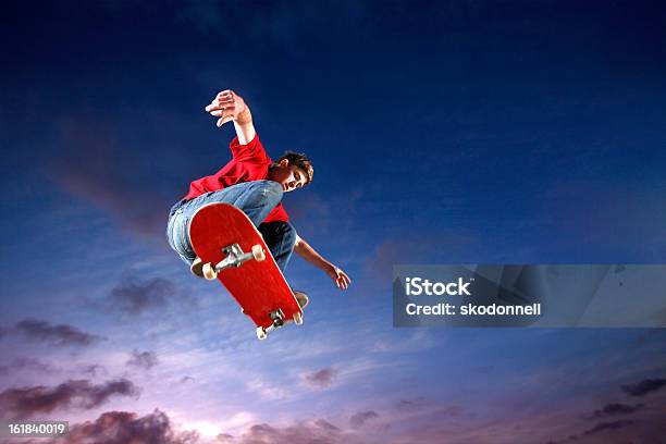 Skateboarder Flying Through The Air Stock Photo - Download Image Now - Skateboarding, Skateboard, Red