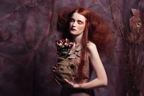 istock beautiful girl with dry roses 1618403282