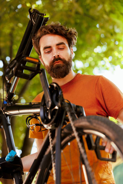 istock Man engaged in bicycle tire repair 1618406824