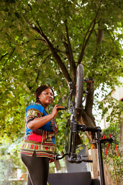 istock Woman inspecting bicycle pedal 1618411185