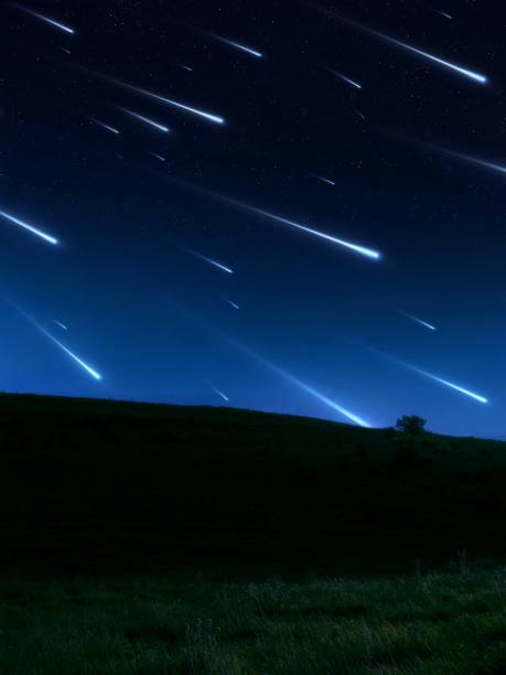 istock Star rain over the hill. Meteor shower in a clear sky. 1618412147