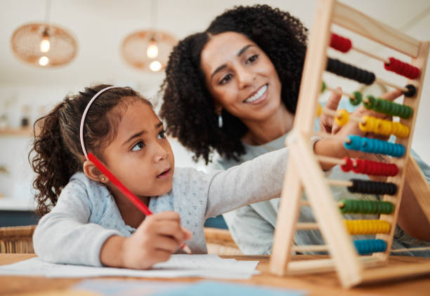 istock Math, child learning and mother for home education, numbers support or helping in kindergarten development. Happy mom, woman and girl kid writing abacus numbers on paper, school and family teaching 1618413738