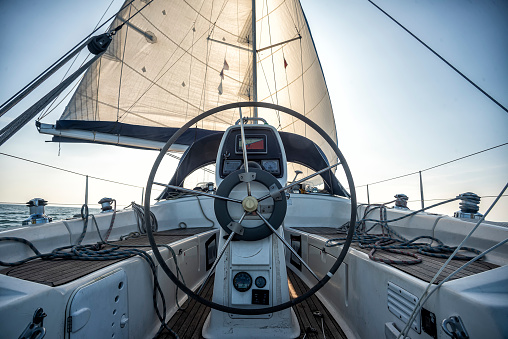 steering wheel in the cockpit of a sailing yacht