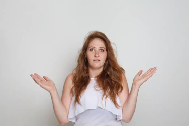 istock Unhappy shocked woman on white background 1618424256