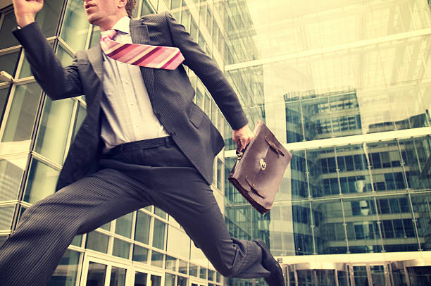 istock Young Businessman Running Outdoors Modern Office Building 161842462