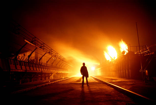 istock Silhouette of a man standing with burning buildings around 161842554