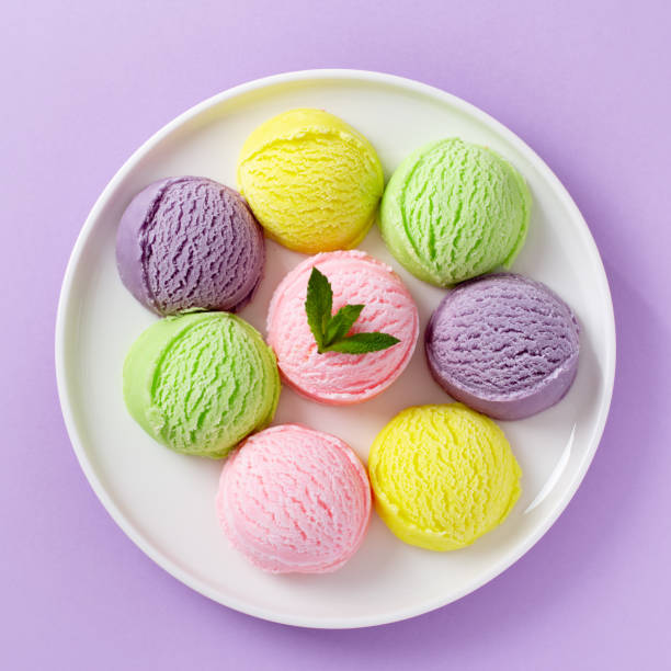 istock Pastel colored ice cream scoops on white plate, top view. 1618432860