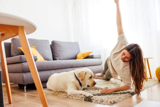istock Woman doing home workout with her dog 1618432884