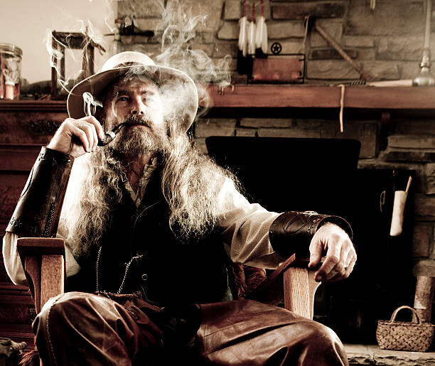 istock Old-Fashioned Western Cowboy Smoking a Pipe 161843735