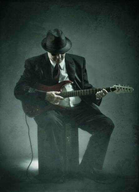 istock elegant senior playing an electric guitar 161843778