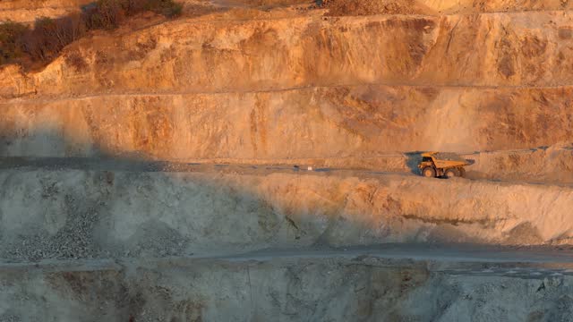 Production useful minerals. Mining dumper truck mining machinery transport ore from open-pit production site, slow motion