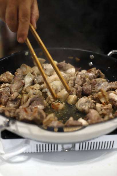 istock chef cooking a stew in the kitchen with frying pan 1618440648