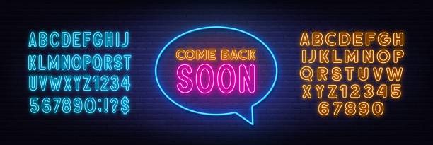 Come Back Soon neon sign in the speech bubble on brick wall background. Yellow and blue neon alphabets.