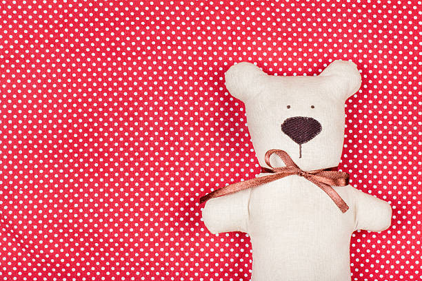 istock Toy bear on red and white cotton background 161844798