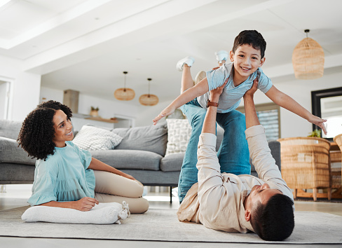 Play, mother or father with a boy on floor relaxing as a happy family bonding in Australia with love or care. Portrait, airplane or parents smile with kid enjoying quality time on a fun holiday