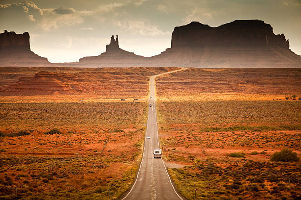 RV drives down the highway  monument valley stock pictures, royalty-free photos & images