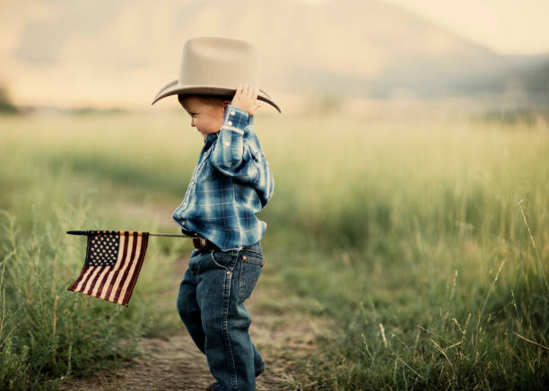 Young American Cowboy A young boy shows his love for the United States of America. wild west photos stock pictures, royalty-free photos & images