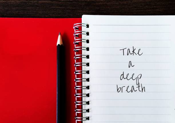 istock Pencil on red notebook with hand written text TAKE A DEEP BREATH, concept of to pause for a moment to compose or calm oneself, act of exhaling is thought to promote calmness 1618457854