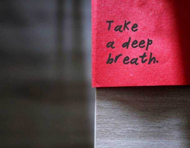 istock Red sticky note with text written TAKE A DEEP BREATH  - concept of self reminder to calm down and take it easy with mindfulness and persistence 1618458387