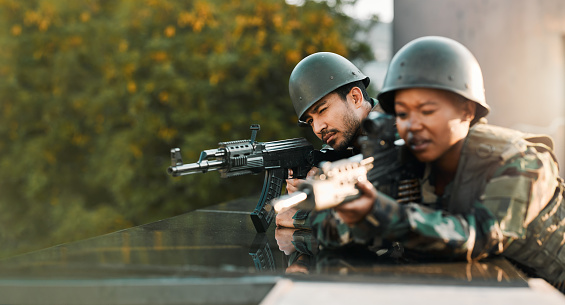 Military, people and gun for training, defense or power on rooftop for aim, shooting or practice. Army, weapon and black woman with man soldier and sniper rifle for war, target or protection team