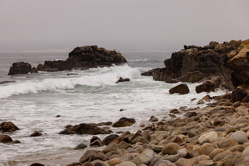 Waves crashing on rocks in Pacific Grove, California