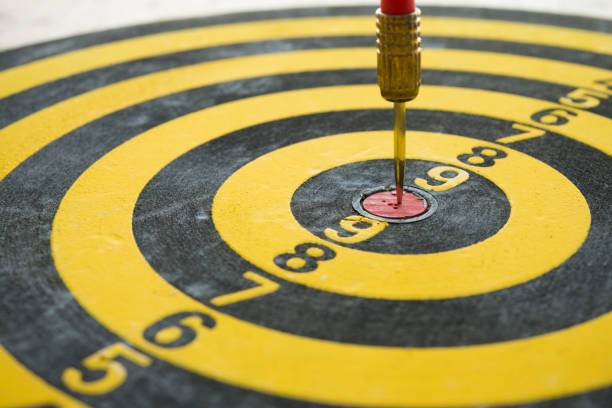 istock Darts arrow hitting on center of dartboard. 1618472123