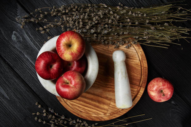 still life, apples on a black background still life, apples on a black background surrounded by dried flowers unusual basket stock pictures, royalty-free photos & images