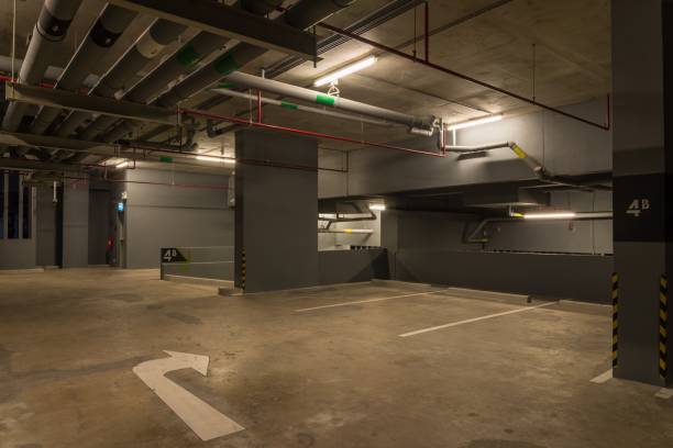 istock Parking garage interior in building at night with warm lighting. 1618479796