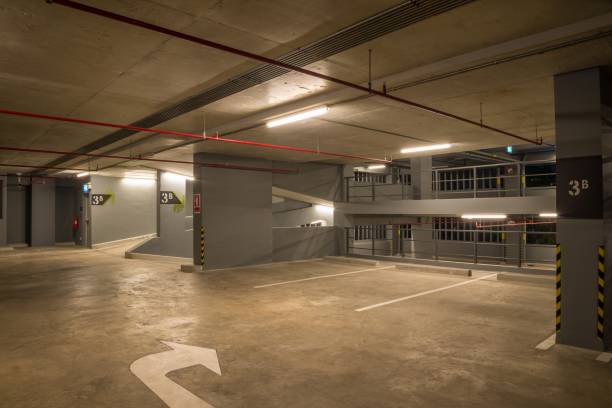 istock Parking garage interior in building at night with warm lighting. 1618479797
