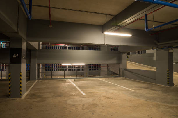 istock Parking garage interior in building at night with warm lighting. 1618480317
