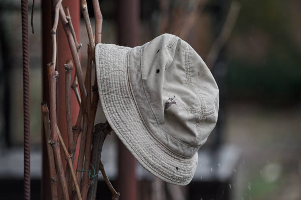 old forgotten hat on an iron fence