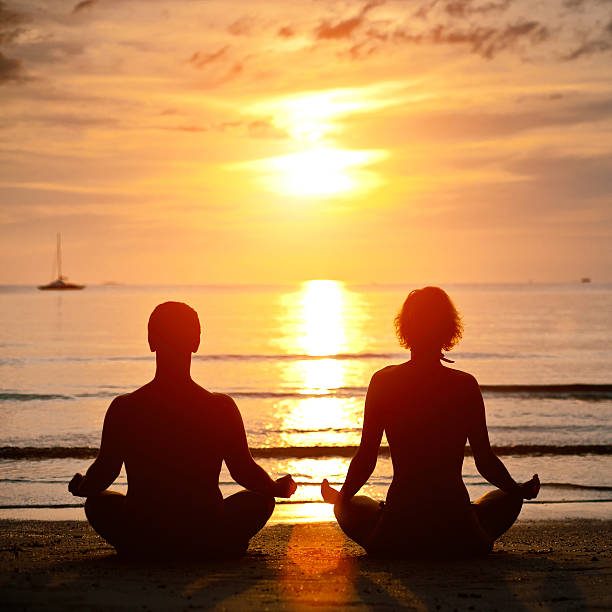 istock Yoga practice, young couple sitting on the beach 161849681