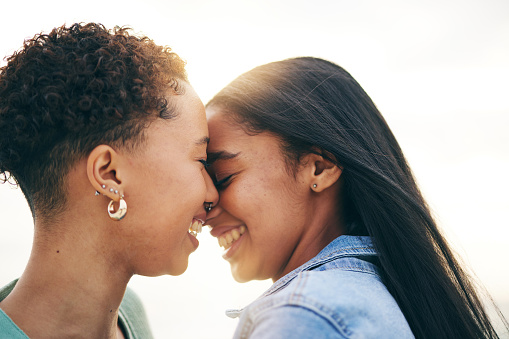 Lesbian couple, love and intimate outdoor at sunset, bonding and romance on date together. Happy, gay women and forehead touch for care, commitment and loyalty, trust and support for lgbtq people