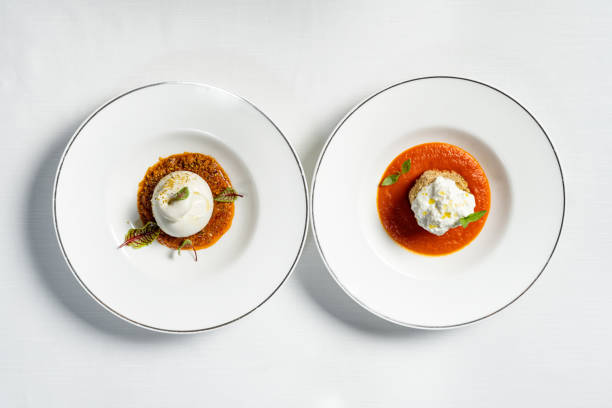 istock Mozzarella with vegetable stew and eggplant breaded with stracciatella cheese. Dishes lie in light ceramic plates on a light tablecloth. Near a glass of white wine. 1618503910