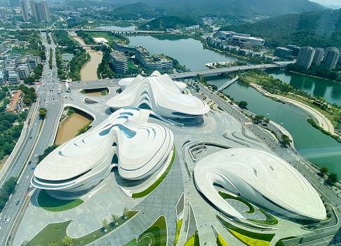 August 2, 2023- Changsha, Hunan, China: Changsha is the capital of Hunan Province, central China. Meixi Lake is a fast growing new area in Changsha and becomes the innovative landmark. Here is the aerial view of Meixi Lake International Culture & Arts Center Theater, designed by the legendary designer- Zaha Hadid. It looks like three blossom of cottonrose hibiscus flower seen from the air.