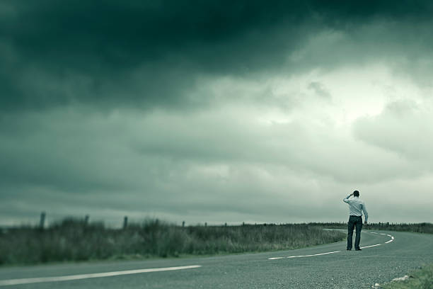 istock Man looking out on dark country road 161851483