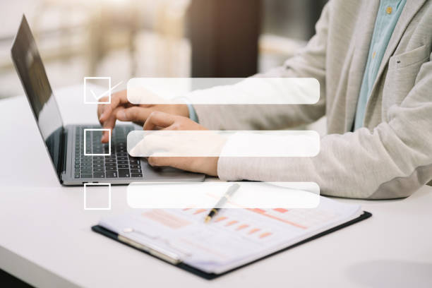 istock Business performance checklist concept, businessman using tablet and laptop doing online checklist survey, filling out digital form checklist. 1618516544