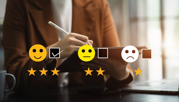 istock Woman holding a digital tablet with checkboxes rating smiley faces excellent for Satisfaction Survey, Happy Client Customer Experience concept. 1618516916