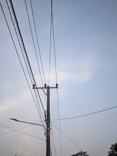 istock Power poles with hanging wires and evening sky background 1618519273