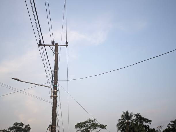 istock Power poles with hanging wires and evening sky background 1618521442